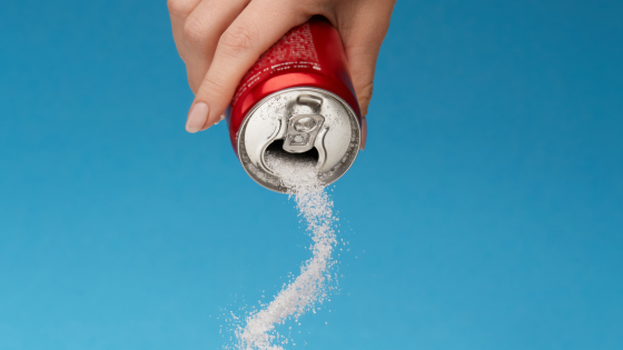 a female hand tips a red can and powdered sugar pours out